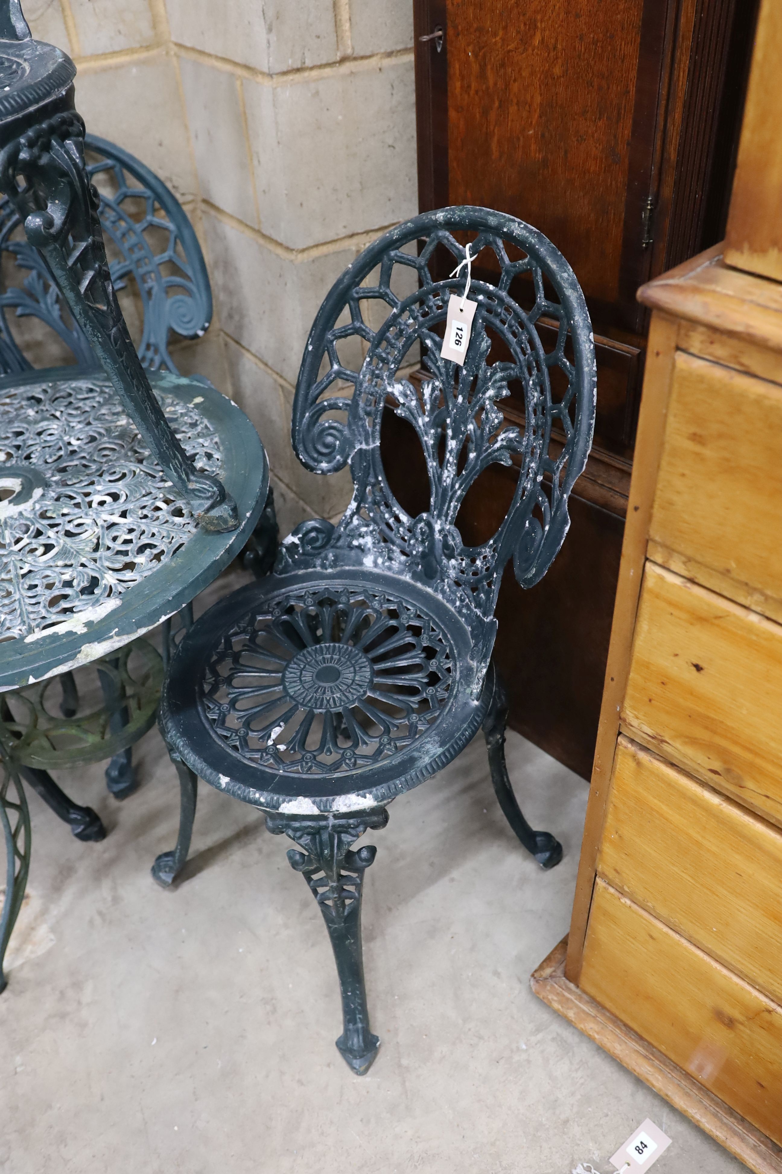 A Victorian style aluminium circular garden table, diameter 60cm, height 62cm and four chairs